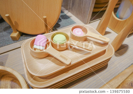 Cute sweets arranged on a wooden plate and wooden spoon. 139875580