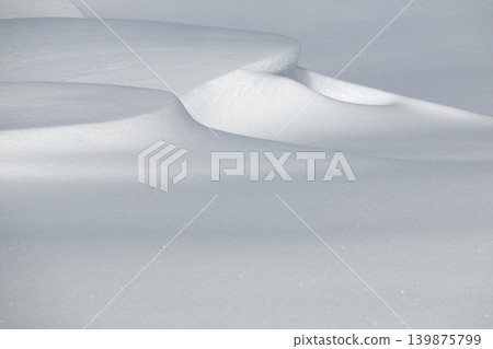 Small snowdrift on flat white winter snow surface Small snowdrift on flat white winter snow surface 139875799