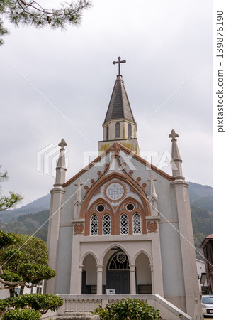 A historic Catholic church in Tsuwano, surrounded by pine trees and mountains. A historic Catholic church in Tsuwano, surrounded by pine trees and mountains. 139876190