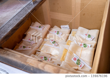 Deep-fried tofu offerings neatly arranged in a wooden display box. Deep-fried tofu offerings neatly arranged in a wooden display box. 139876196