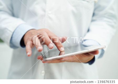 Doctor checking and note diagnosis medicine in clipboard of patients in hospital. Doctor checking and note diagnosis medicine in clipboard of patients in hospital. 139876335