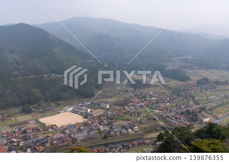 A hazy panoramic view of the Tsuwano Valley, with its farmland and mountains. A hazy panoramic view of the Tsuwano Valley, with its farmland and mountains. 139876355