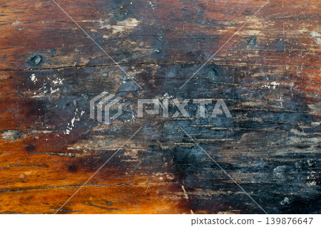 Brown wooden background with the scratch and black burning part 139876647
