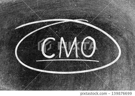 White chalk hand writing in word CMO (Abbreviation of Chief Marketing Officer, Contract Manufacturing Organization) and circle shape on blackboard background White chalk hand writing in word CMO (Abbreviation of Chief Marketing Officer, Contract Manufacturing Organization) and circle shape on blackboard background 139876699