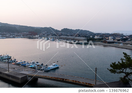A panoramic view of Hagi Fishing Port at dusk (fishing boats, quay, warehouses) 139876962