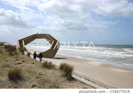 De Panne, Flanders, Belgium Abstract Coastal Structure on a Sandy Beach with Distant Ocean Waves and People Explore Modern Art De Panne, Flanders, Belgium Abstract Coastal Structure on a Sandy Beach with Distant Ocean Waves and People Explore Modern Art 139877028