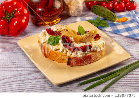 Italian bruschetta with ricotta cheese, sun dried tomato and artichoke 139877075