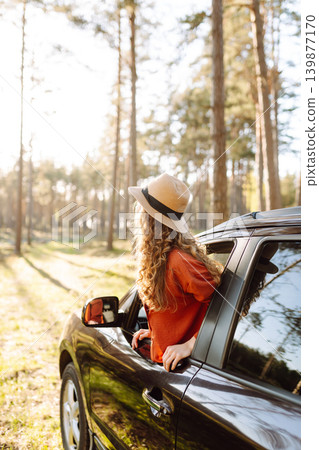 Happy woman in car window. Hair in wind. Road trip. Lifestyle, travel, tourism, nature, active life Happy woman in car window. Hair in wind. Road trip. Lifestyle, travel, tourism, nature, active life 139877170