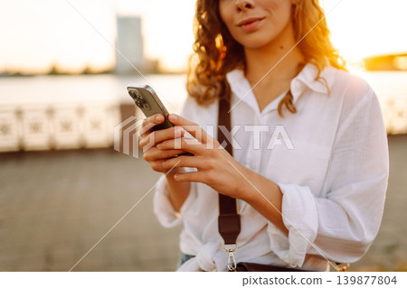 A young woman using her smartphone. Concept of vocational, blogging, technology, weekend. A young woman using her smartphone. Concept of vocational, blogging, technology, weekend. 139877804