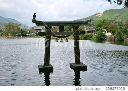 The stone torii gate of Kinrin Lake stands on the water, creating a sacred atmosphere. The stone torii gate of Kinrin Lake stands on the water, creating a sacred atmosphere. 139877910
