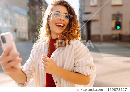 Happy woman tourist with phone. Young woman writing text for sharing content about vacations Happy woman tourist with phone. Young woman writing text for sharing content about vacations 139878227
