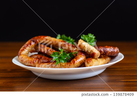 homemade barbecue sausages served with fresh parsley garnish homemade barbecue sausages served with fresh parsley garnish 139878409