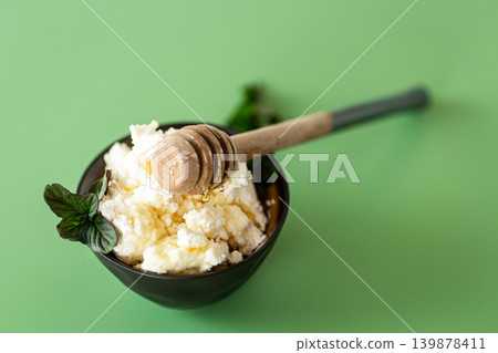 nutritious dairy product with honey on warm background nutritious dairy product with honey on warm background 139878411