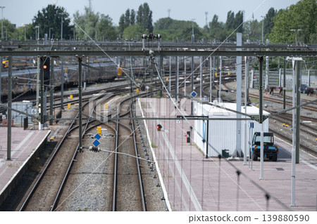 Busy railway yard with trains, tracks, red signals and dense overhead electric Busy railway yard with trains, tracks, red signals and dense overhead electric 139880590