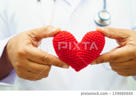 Asian woman doctor holding red heart for health in hospital. 139880888