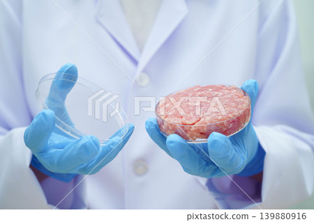 Scientist holding Petri dish with meat in science laboratory for food product development. Scientist holding Petri dish with meat in science laboratory for food product development. 139880916