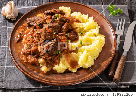 slow cooked beef meat stew served with mashed potatoes 139881260