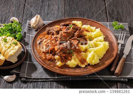 slow cooked beef meat stew served with mashed potatoes slow cooked beef meat stew served with mashed potatoes 139881261