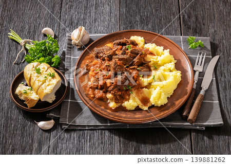 slow cooked beef meat stew served with mashed potatoes slow cooked beef meat stew served with mashed potatoes 139881262