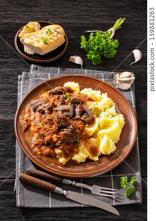 slow cooked beef meat stew served with mashed potatoes slow cooked beef meat stew served with mashed potatoes 139881263