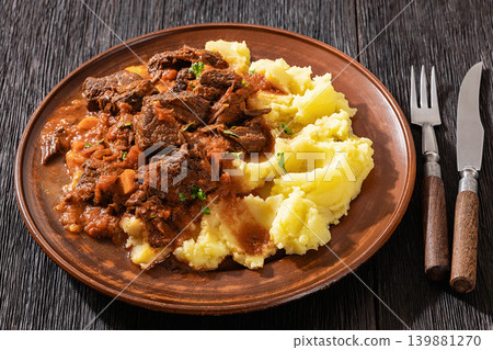 slow cooked beef meat stew served with mashed potatoes slow cooked beef meat stew served with mashed potatoes 139881270