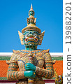 A green-faced yaksha guardian Thotsakan against blue sky at Wat Phra Kaew, Grand Palace, Bangkok, Thailand 139882201