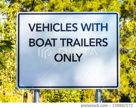 A no parking sign notification in a public carpark near a river 139882572