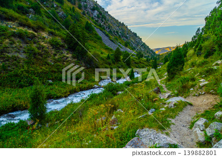 Scenic Mountain Valley with River and Hiking Trail at Sunset in Kyrgyzstan Scenic Mountain Valley with River and Hiking Trail at Sunset in Kyrgyzstan 139882801