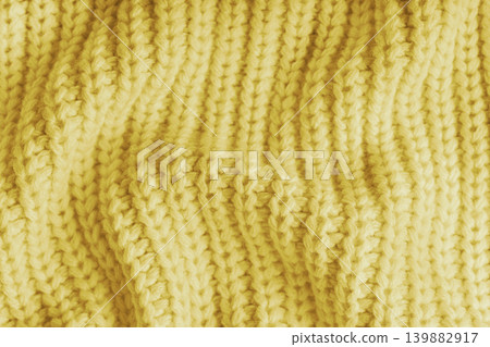 Crumpled yellow knitted fabric texture with folds, wrinkles and soft waves, wool background 139882917