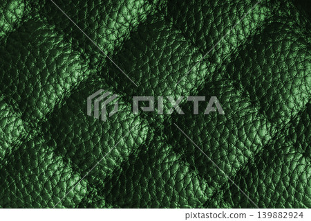 Macro of green quilted leather texture background with stitched pattern and shining metal effect Macro of green quilted leather texture background with stitched pattern and shining metal effect 139882924