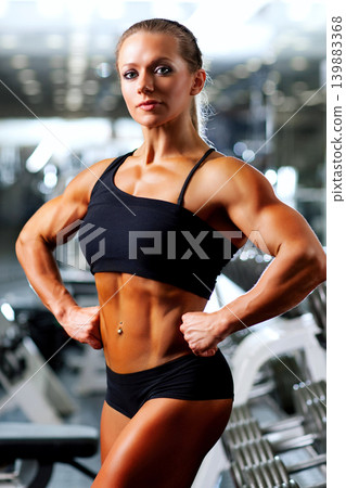 Young sports woman posing in gym Young sports woman posing in gym 139883368