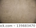 Beige textured concrete or plaster wall background with vignette 139883470