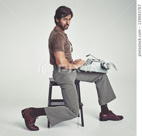 Man, vintage and pipe with typewriter in studio on grey background, confident and typing in chair. Fashion, retro and smart style in old school with elegance on fashionable and fancy clothes. 139883767