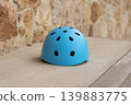 Blue helmet on concrete surface minimal safety sport equipment concept 139883775