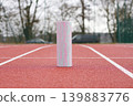 Foam roller on running track outdoor recovery fitness training concept 139883776