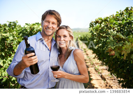 Vineyard, portrait and couple with glass of wine in marriage, nature and smile for honeymoon trip for alcohol. People, happiness and standing in farm for agriculture with fruit and drink for love Vineyard, portrait and couple with glass of wine in marriage, nature and smile for honeymoon trip for alcohol. People, happiness and standing in farm for agriculture with fruit and drink for love 139883854