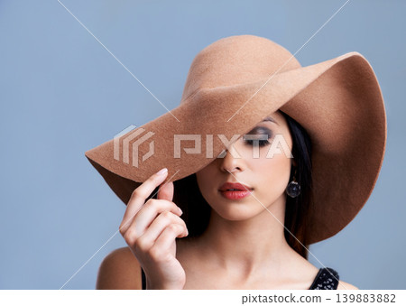 Beauty, cosmetics and woman in hat with glamour, confidence and vintage style in studio. Classic, chic and elegant model in cool aesthetic with girl on grey background for luxury, grace and makeup. Beauty, cosmetics and woman in hat with glamour, confidence and vintage style in studio. Classic, chic and elegant model in cool aesthetic with girl on grey background for luxury, grace and makeup. 139883882