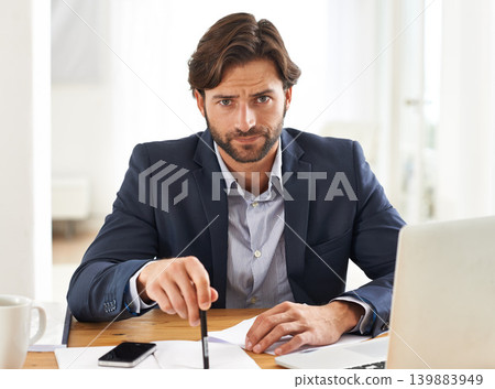 Desk, laptop and portrait of businessman with anger, paperwork and serious financial analyst in office. Consultant, business advisor or frustrated man with computer, documents and notes at startup. Desk, laptop and portrait of businessman with anger, paperwork and serious financial analyst in office. Consultant, business advisor or frustrated man with computer, documents and notes at startup. 139883949
