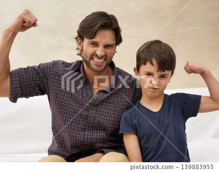 Sofa, muscle and portrait of father and child flex for bonding, fun childhood and relax together. Family, home and strong dad with young son on couch for love, care and support in living room Sofa, muscle and portrait of father and child flex for bonding, fun childhood and relax together. Family, home and strong dad with young son on couch for love, care and support in living room 139883955