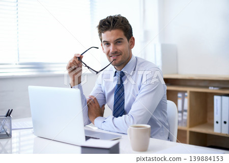Businessman, portrait and smile at laptop in office with confidence as financial advisor or investment, loan or budget. Male person, face and glasses as broker or online planning, research or funding Businessman, portrait and smile at laptop in office with confidence as financial advisor or investment, loan or budget. Male person, face and glasses as broker or online planning, research or funding 139884153