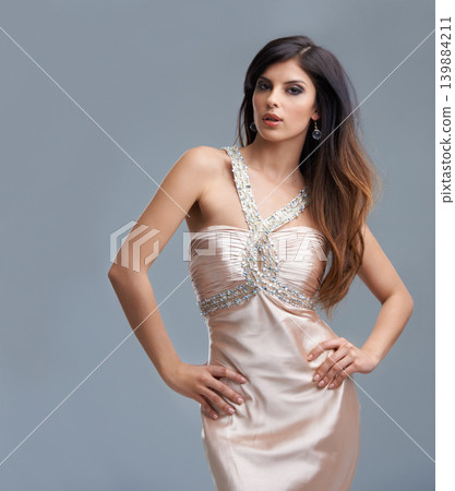 Fashion, glamour and portrait of woman in studio with confidence, beauty and luxury dress. Attractive, aesthetic and person with stylish clothes, chic style and designer outfit on gray background Fashion, glamour and portrait of woman in studio with confidence, beauty and luxury dress. Attractive, aesthetic and person with stylish clothes, chic style and designer outfit on gray background 139884211