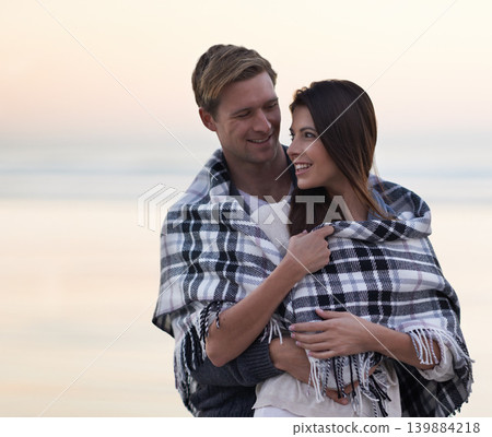 Couple, hug and sunset at beach with blanket for vacation, love and care in nature, outdoor and ocean. Man, woman and embrace with smile, bonding and happy for memory on holiday by sea in Australia Couple, hug and sunset at beach with blanket for vacation, love and care in nature, outdoor and ocean. Man, woman and embrace with smile, bonding and happy for memory on holiday by sea in Australia 139884218