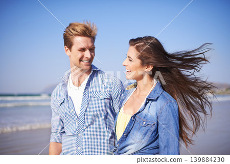 Couple, smile and walk on beach for romantic date on sunny afternoon with blue sky in New Zealand. Happy, man and woman in love for sweet relationship, fun dating and bonding together in summer Couple, smile and walk on beach for romantic date on sunny afternoon with blue sky in New Zealand. Happy, man and woman in love for sweet relationship, fun dating and bonding together in summer 139884230