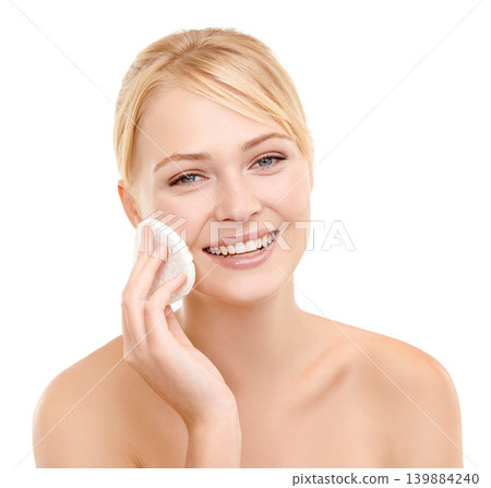 Beauty, cotton pad and portrait of woman in studio with natural, health and skincare face routine. Glow, smile and female model from Australia with facial dermatology treatment by white background. Beauty, cotton pad and portrait of woman in studio with natural, health and skincare face routine. Glow, smile and female model from Australia with facial dermatology treatment by white background. 139884240