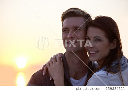 Love, hug and couple at ocean with sunset sky for tropical holiday adventure, relax and bonding together. Commitment, happy man and woman on romantic date with ocean, evening and embrace on vacation. Love, hug and couple at ocean with sunset sky for tropical holiday adventure, relax and bonding together. Commitment, happy man and woman on romantic date with ocean, evening and embrace on vacation. 139884311