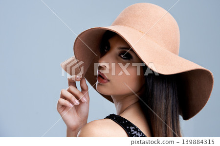 Fashion, makeup and woman in hat with glamour, confidence and pride in studio. Classic, vintage chic and elegant style with girl on grey background for designer cosmetics, classy and cool aesthetic. Fashion, makeup and woman in hat with glamour, confidence and pride in studio. Classic, vintage chic and elegant style with girl on grey background for designer cosmetics, classy and cool aesthetic. 139884315