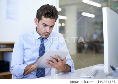 Businessman, tablet and reading in office for online research or communication for networking, project planning or internet. Male person, desk and sales report or New York consultant, email or web Businessman, tablet and reading in office for online research or communication for networking, project planning or internet. Male person, desk and sales report or New York consultant, email or web 139884371