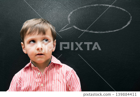 Child, boy and thinking with speech bubble on blackboard for creative idea, drawing and illustration in classroom. Student, kid and face with daydreaming, contemplating and question with chalkboard Child, boy and thinking with speech bubble on blackboard for creative idea, drawing and illustration in classroom. Student, kid and face with daydreaming, contemplating and question with chalkboard 139884411