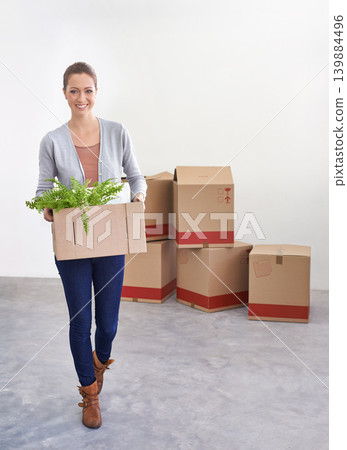 Portrait, new home and woman with boxes, moving and real estate with rental apartment and property. Person, plant and girl with achievement and personal development with package and house on a loan Portrait, new home and woman with boxes, moving and real estate with rental apartment and property. Person, plant and girl with achievement and personal development with package and house on a loan 139884496