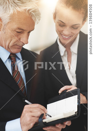 Leader, showing and notebook to worker in workplace for business in corporate company for strategy. Woman, smile and talking to boss in office, happy and professional in clothes for work or job 139884508